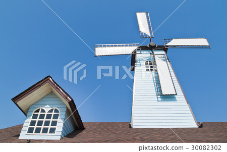 wind turbines and window on roof with blue sky wind turbines and window on roof with blue sky 30082302