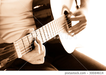 Girl playing guitar,hand focus sepia tone. Girl playing guitar,hand focus sepia tone. 30084614