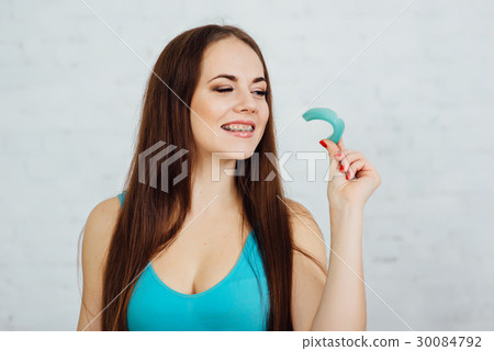 Girl boxer with braces holding gloves and cape 30084792