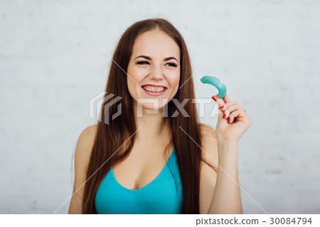Girl boxer with braces holding gloves and cape Girl boxer with braces holding gloves and cape 30084794