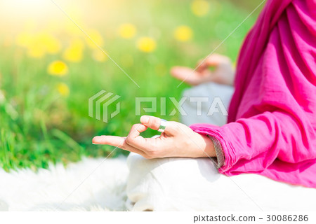 Position yoga practice it a woman in nature in spring flowers Position yoga practice it a woman in nature in spring flowers 30086286