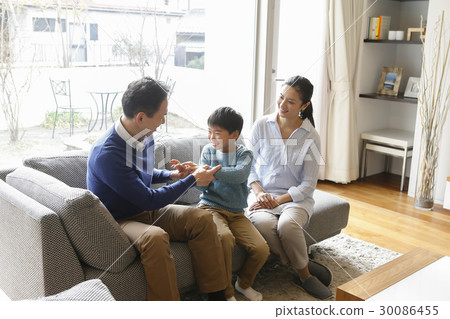 A family relaxing in the living room A family relaxing in the living room 30086455