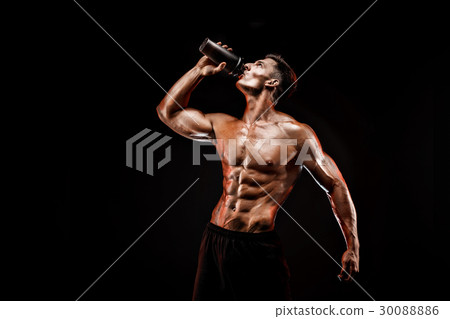 Muscular man with protein drink in shaker over 30088886