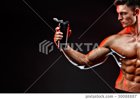 Muscular man with protein drink in shaker over 30088887