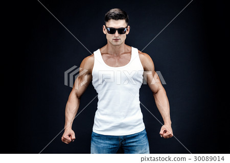 Handsome muscular man in dark glasses and a white Handsome muscular man in dark glasses and a white 30089014