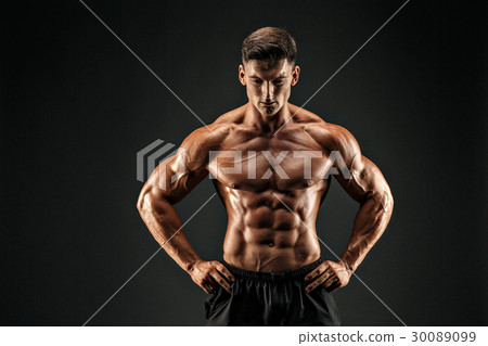 bodybuilder posing. Beautiful sporty guy male 30089099