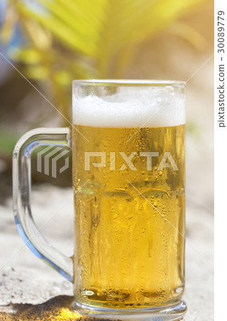 Glasses of beer on beach Glasses of beer on beach 30089779