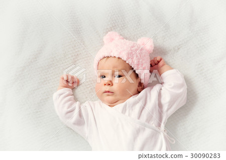 Cute newborn baby girl lying in the bed Cute newborn baby girl lying in the bed 30090283