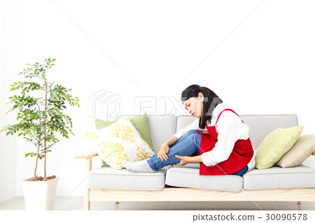 A housewife suffering while drinking coffee sitting on the sofa A housewife suffering while drinking coffee sitting on the sofa 30090578