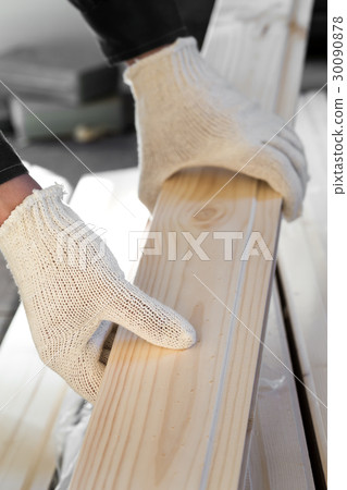 Hands in fabric gloves holding wooden plank Hands in fabric gloves holding wooden plank 30090878