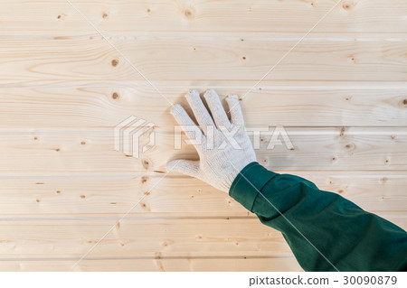Human palm in gloves on tongue and groove wall 30090879