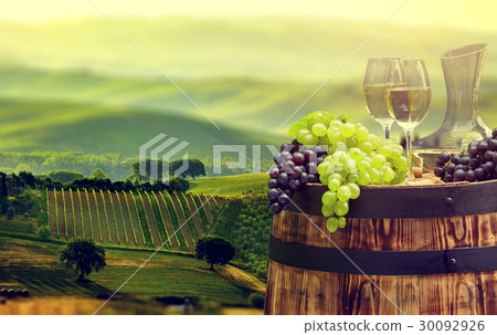 White wine bottle and  glass on wodden barrel. 30092926