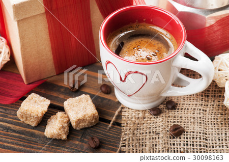 cup of coffee, gift with red ribbon, brown sugar 30098163