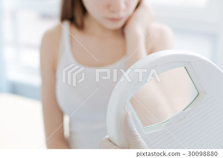 Professional dermatologist using medical loupe for 30098880