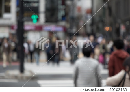 People crossing a pedestrian crossing People crossing a pedestrian crossing 30102183