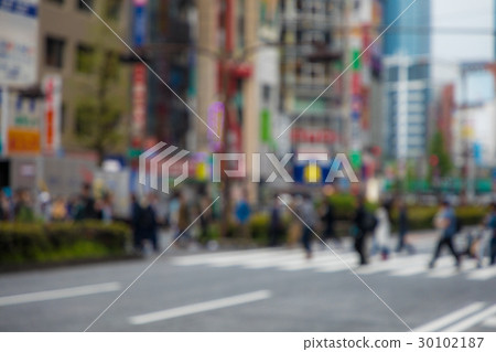 People crossing a pedestrian crossing People crossing a pedestrian crossing 30102187