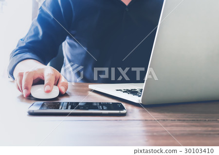 businessman hand working laptop on wooden desk. businessman hand working laptop on wooden desk. 30103410