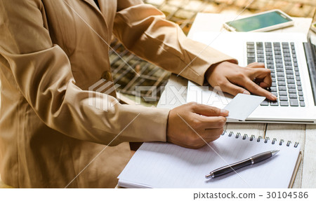 Young manager working with notebook in the office Young manager working with notebook in the office 30104586