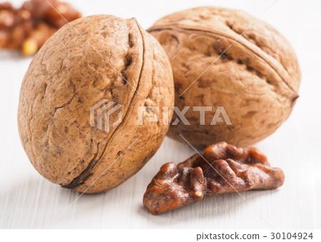 inshell walnut on white wooden background 30104924