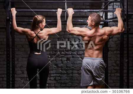 Rear view photo of muscular man and woman doing 30106766