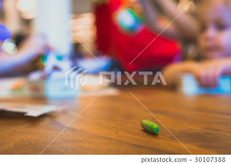 Green color pastel crayon on brown wooden table 30107388