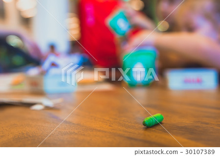 Green color pastel crayon on brown wooden table Green color pastel crayon on brown wooden table 30107389