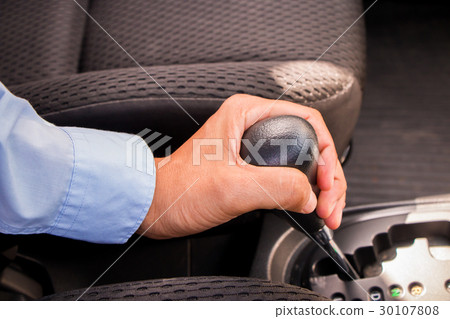 A business man holding gear A business man holding gear 30107808