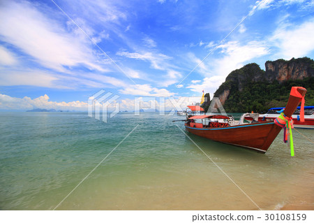 long boat and rocks on beach in Krabi, Thailand 30108159