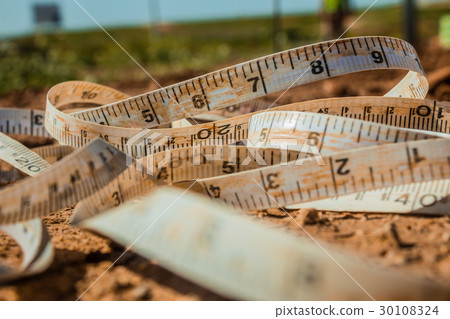 Measuring tape placed on the ground 30108324