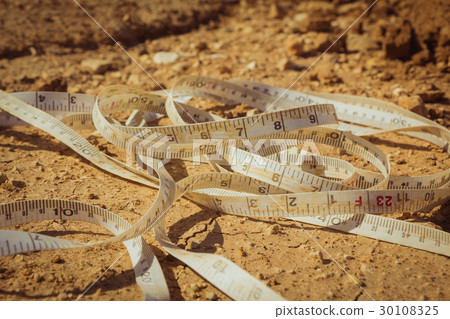 Measuring tape placed on the ground Measuring tape placed on the ground 30108325