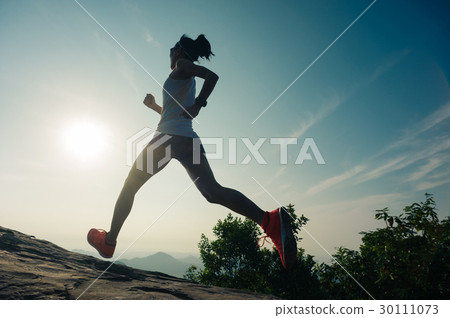 woman trail runner running at mountain top 30111073