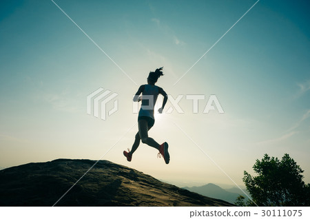 woman trail runner running at mountain top 30111075