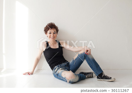 the girl with the short hair sitting on the floor the girl with the short hair sitting on the floor 30111267