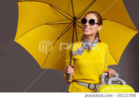 Glamour woman with yellow umbrella and suitcase 30111700