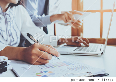 Business team analyzing income Business team analyzing income 30113345