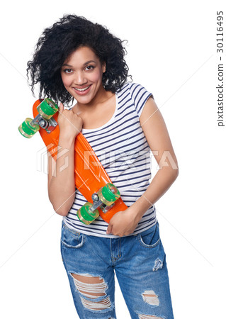 Happy female in distressed jeans with skateboard 30116495