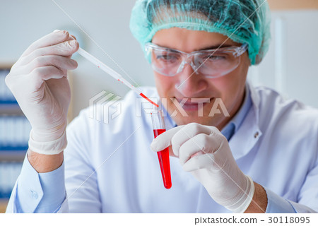 The young doctor working on blood test in lab 30118095
