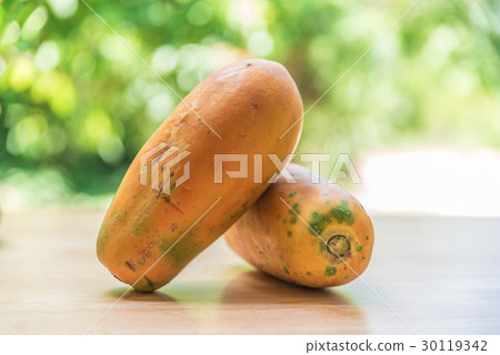 Papaya fruit on wooden table with blur background Papaya fruit on wooden table with blur background 30119342