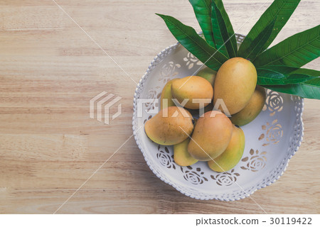 Mango on a wood background 30119422