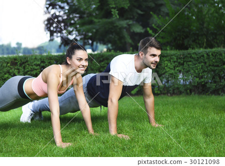 Young couple exercising and stretching Young couple exercising and stretching 30121098