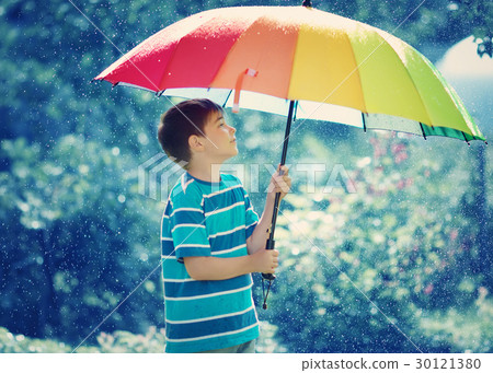 Child walking on rainy weather Child walking on rainy weather 30121380