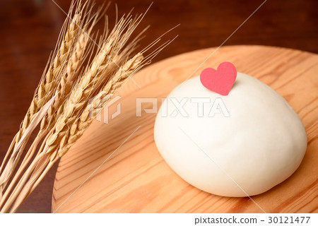 Dough and wheat on heart and cutting board 30121477