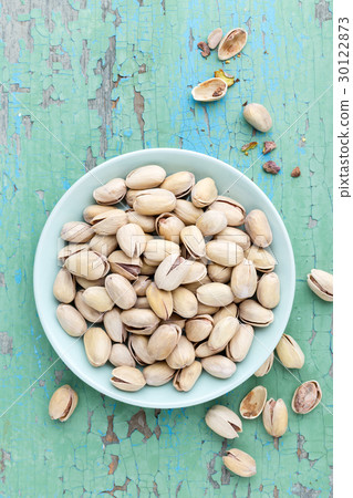 Pistachio nuts on wooden background, top view Pistachio nuts on wooden background, top view 30122873