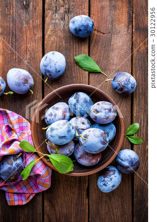 Fresh plums with green leaves Fresh plums with green leaves 30122956