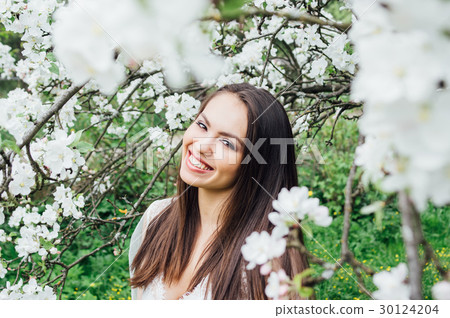Portrait of young girl in white dress with flowers Portrait of young girl in white dress with flowers 30124204