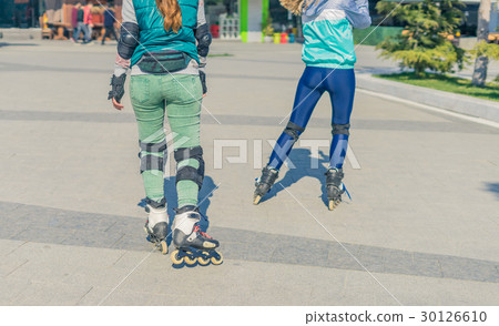 Two girls rollers go one after another Two girls rollers go one after another 30126610