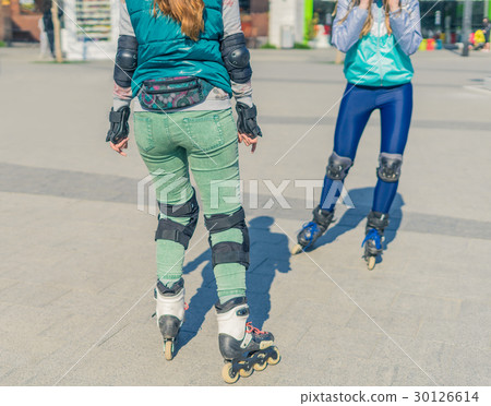 Two girls rollers meet each other in the park Two girls rollers meet each other in the park 30126614