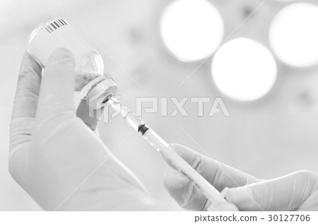 Hand holding syringe and medicine vial Hand holding syringe and medicine vial 30127706