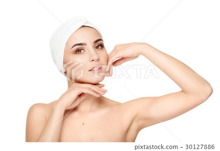 Beautiful young woman touching her face on a white Beautiful young woman touching her face on a white 30127886