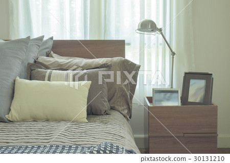 Linen pillows in difference size on bed in bedroom 30131210